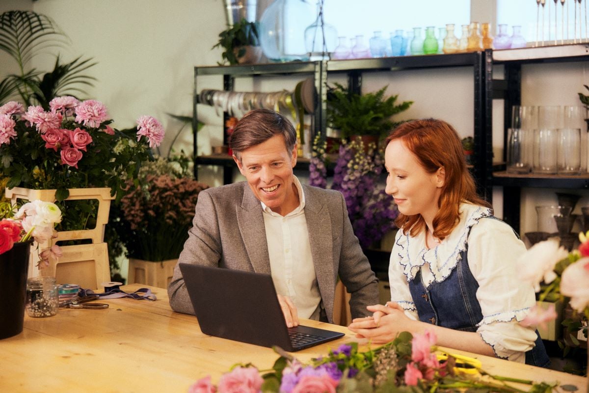 Accountant working with a small business owner in a flower shop