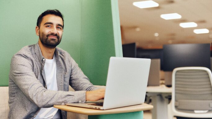 Man doing payroll at laptop