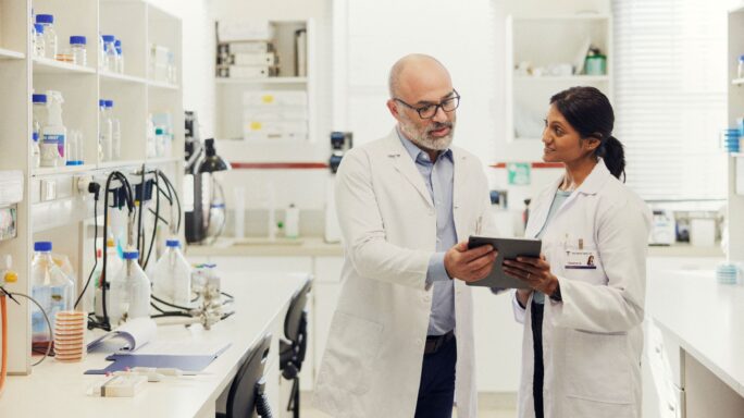 Two chemists working in a lab