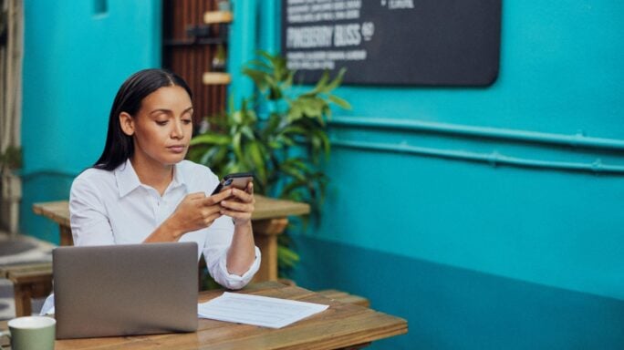 Woman doing payroll at cafe