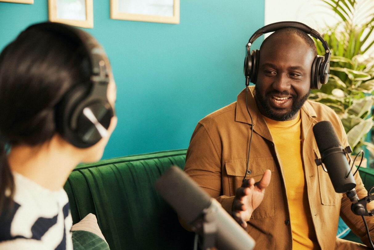 Man and woman recording a podcast in an office