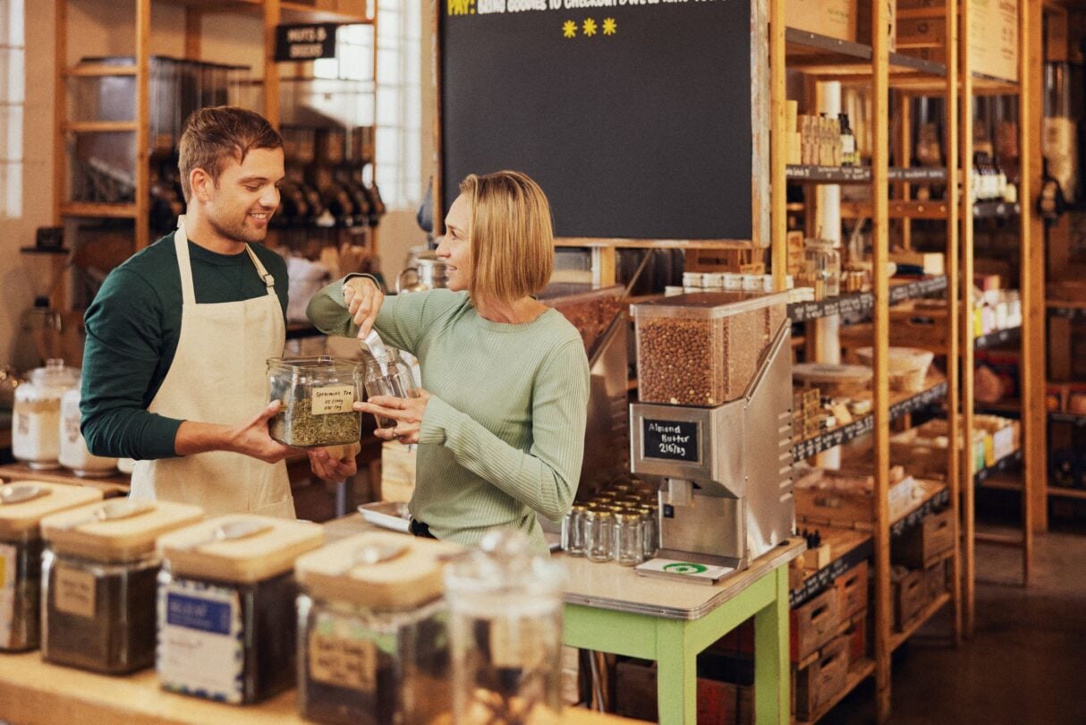 Two colleagues working in a small coffee shop