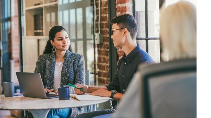 A group of people during a meeting in an office.