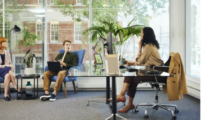 People in an office having a discussion.