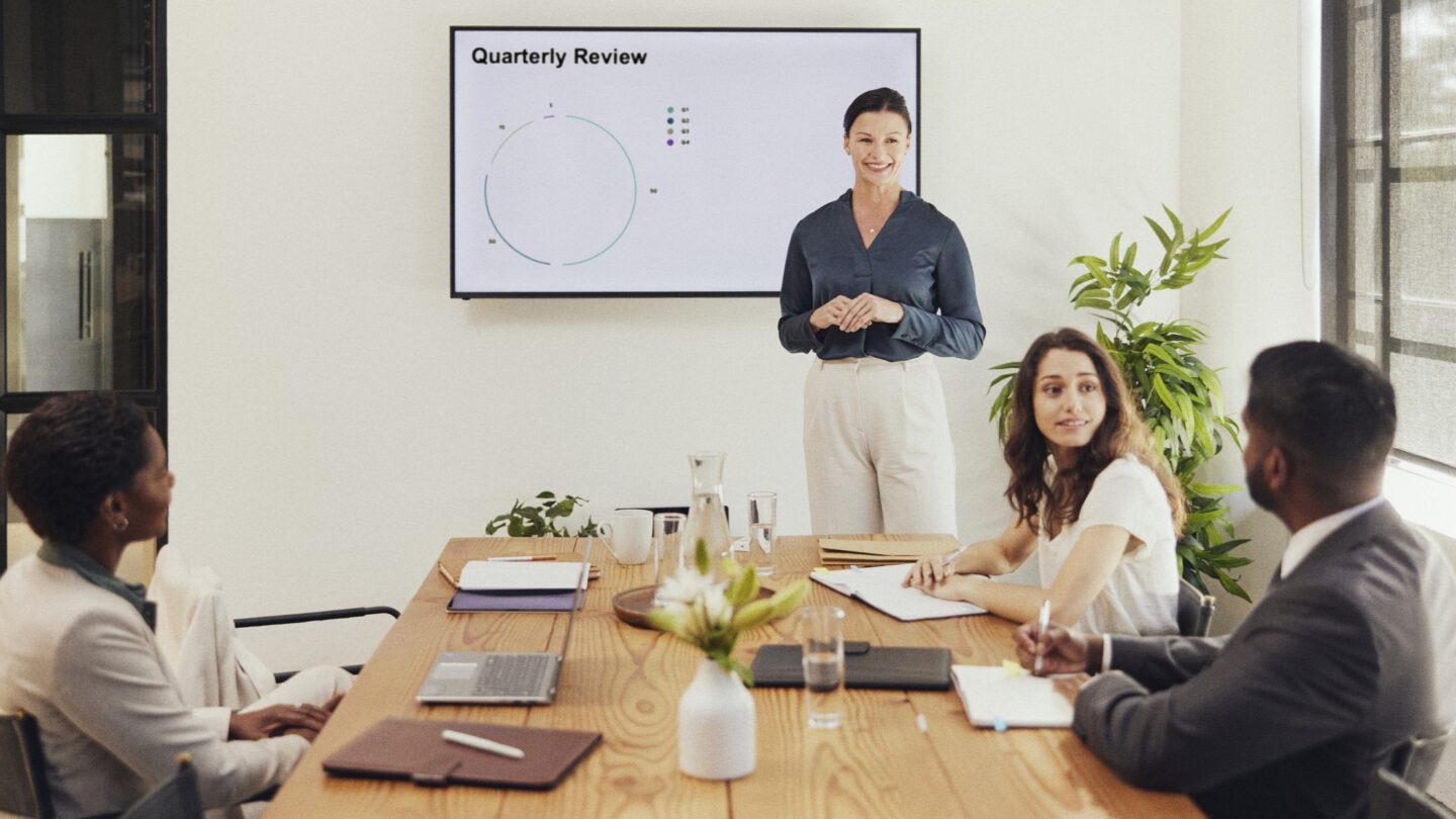 A group of finance professionals have a discussion during a meeting.