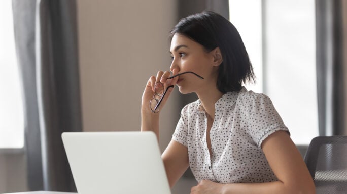 Thoughtful business woman looking away thinking solving problem at work